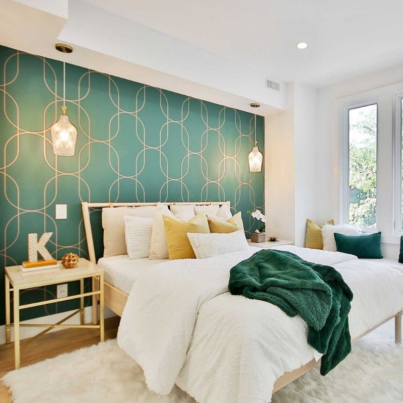 Modern bedroom with a green feature wall, decorative pattern wallpaper and fresh interior finishes completed by a Sydney Painter.